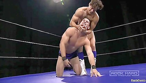 Hot guy in black trench coat is wrestling with a muscular partner